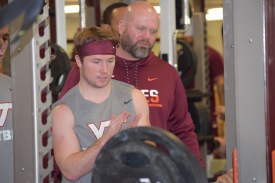 Blacksburg, Va., Sept. 6- PUSHING TEAMMATES: A key expectation of preferred walk-ons is the job of pushing starters. Here, Carroll cheers on his teammates completing a set of benchpress. Photo: Blayne Fink